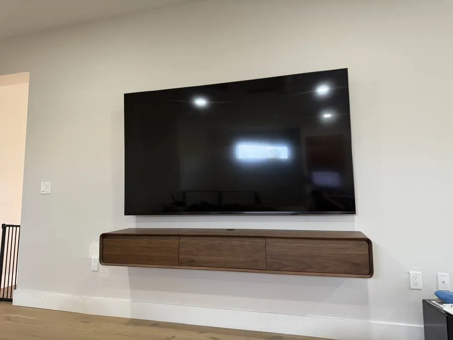 TV with floating walnut shelf