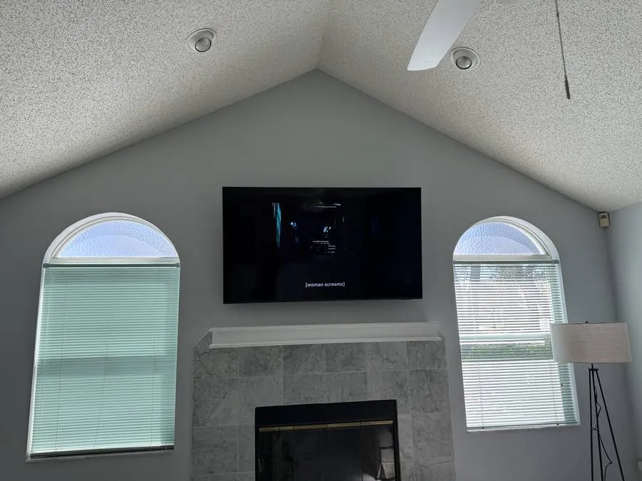 TV above fireplace vaulted ceiling