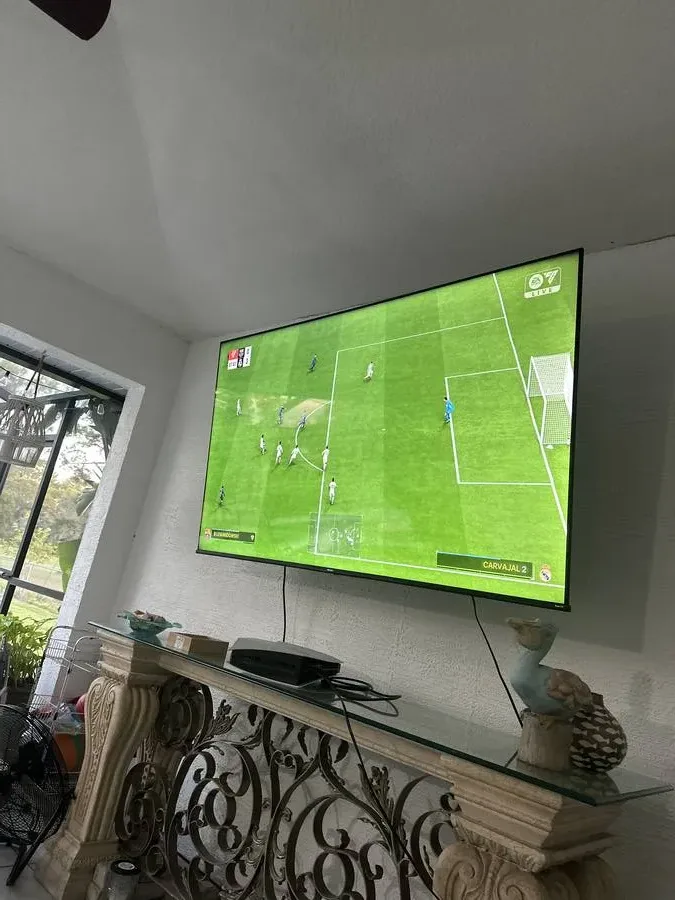 Living room TV mount above mantel